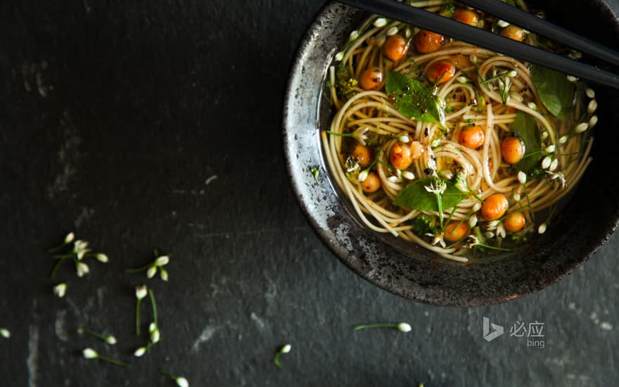 A bowl of noodles on a dark table