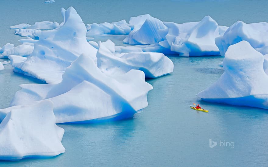 A kayaker crosses Grey Lake in Torres del Paine National Park, Chile